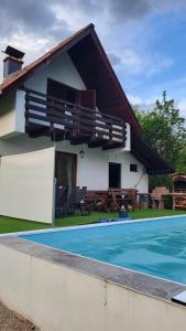 a house with a swimming pool in front of it at Oaza Mira-vikend kuca sa bazenom in Pale