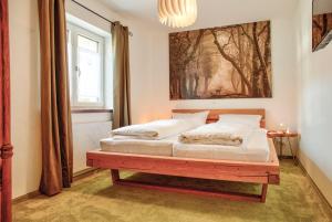 a bedroom with two beds and a painting on the wall at Ferienwohnung Biobauernhof Peter Anderl Hof in Pfreimd