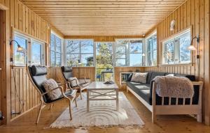 a living room with a couch and chairs and windows at 3 Bedroom Beautiful Home In Grenaa in Grenå