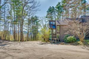 a home in the woods with a large driveway at Half Mile to Ski Slopes Conway Condo with Hot Tub! in North Conway