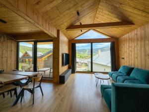 a living room with a blue couch and a table at Chalet Smreky in Telgárt