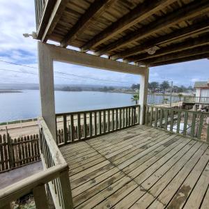 a wooden deck with a view of the water at Max & Mar Pichilemu in Pichilemu