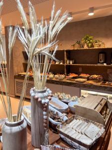 a table with a buffet of food in a bakery at Smart Hotel João Pessoa in João Pessoa