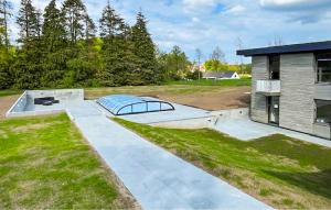 a skateboard ramp in the yard of a house at 10 Bedroom Gorgeous Home In Glesborg in Glesborg
