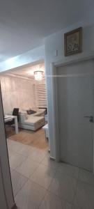 a room with a living room with a couch and a table at LoreHan apartman 2 in Becici +5 photos