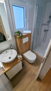 a bathroom with a sink and a toilet and a shower at Mobile Homes Jaki - 2 Bathrooms, Large Terrace in Biograd na Moru