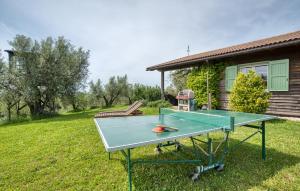 a ping pong table in front of a house at Nice Home In Farnese With Outdoor Swimming Pool in Farnese