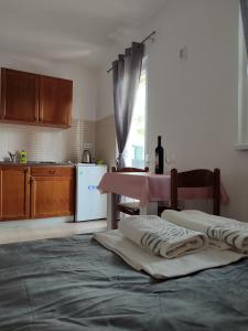 a kitchen with a large bed and a pink table at Apartments Glibić in Zaostrog