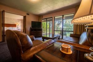 a living room with a couch and a television at Sweetwater at Lake Conroe, a VRI resort in Montgomery