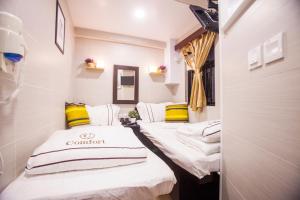 Katil atau katil-katil dalam bilik di Joyous Guest House