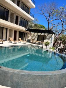 a large swimming pool in front of a building at Casa Azul Residences in Sayulita