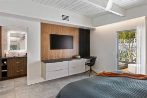 a bedroom with a bed and a tv on a wall at *Condo - 606 W Arenas Rd Unit 3, Palm Springs in Palm Springs