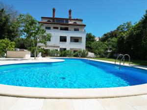 a swimming pool in front of a building at Green House Villa with Pool in Banjole