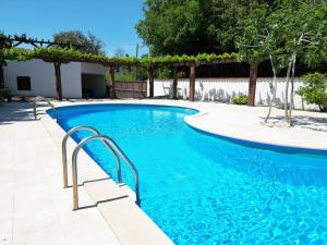 a swimming pool with blue water in a yard at Green House Villa with Pool in Banjole