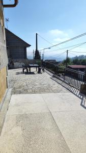 a patio with two benches and a fence at Casa rural completa y con garaje in Vigo