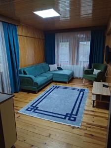 a living room with a couch and a rug at Karagoz Apart Pansiyon in Uzungol