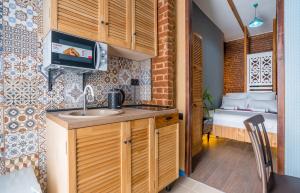 a small kitchen with a sink and a bedroom at Apart View Hotel & Spa in Tbilisi City