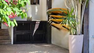 a black door with a plant in front of it at Beach Guest House - GMT in Rio de Janeiro