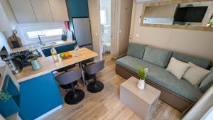 a living room and kitchen with a couch and a table at Mobile Homes Jaki - 2 Bathrooms, Large Terrace in Biograd na Moru