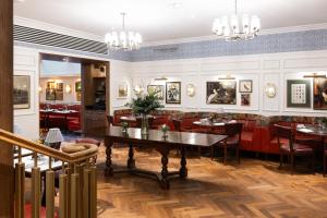 a restaurant with red chairs and a table at The White Hart Hotel Lincoln in Lincoln