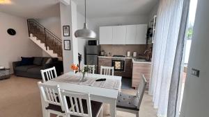 a kitchen and living room with a white table and chairs at Viola's Charming House in Giarre