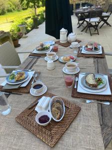 a wooden table with plates of food on it at Château de Monsac in Monsac