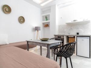 a kitchen with a table and chairs in a room at Premium Naxos Suite Family Suite With Private Balcony Modern Furnishing in Naxos Chora