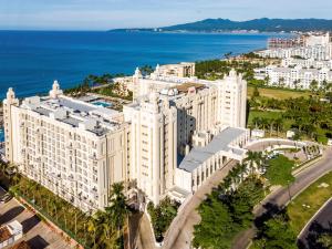 an aerial view of a large white building next to the ocean at Riu Vallarta - All Inclusive in Bucerías