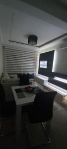 a living room with a table and a couch at LoreHan apartman 2 in Becici