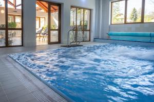 a swimming pool with a wave floor mural at Penzion Praděd Thamm in Zlaté Hory