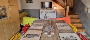 a wooden table in a room with a dining room at L'Hermine Occitane B&B in Gratens