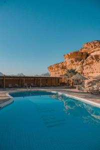 a large swimming pool in the middle of a mountain at aالكـريـم AL KARIM LUXURY CAMP in Wadi Rum