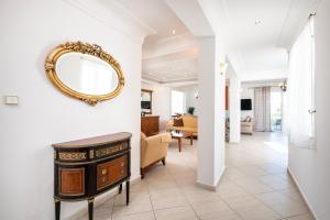 a living room with a mirror on a wall at Aegean Whispers House in Psalidi