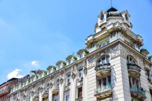 an old building in paris against a blue sky at Republic Square Luxury Suites in Belgrade