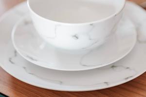 a stack of white cups and saucers on a table at Stylish home w/ parkng, fst wifi in Cambourne