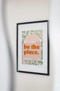 a framed picture on a wall with the words be the place at Stylish home w/ parkng, fst wifi in Cambourne