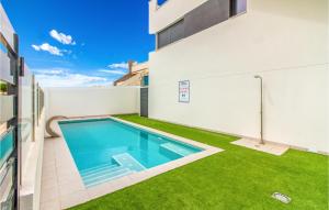 ein Swimmingpool an der Seite eines Gebäudes in der Unterkunft Nice Home In San Pedro Del Pinatar in San Pedro del Pinatar