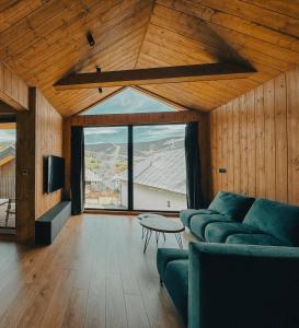 a living room with a couch and a tv at Chalet Smreky in Telgárt