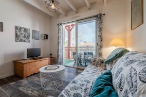 a living room with a couch and a tv and a window at Atlantic Selection - Le Boudigau avec parking in Capbreton