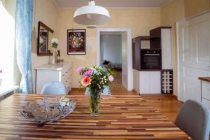 a vase of flowers on a table in a kitchen at Riverview Residence - with parking in Ljubljana