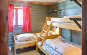 a bunk room with two bunk beds and a window at 3 Bedroom Cozy Home In seral in Åseral