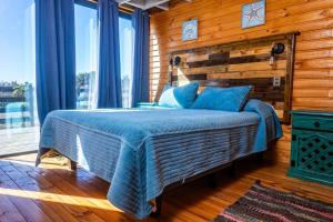 1 dormitorio con 1 cama con pared de madera en PEZ HOUSE en Pichilemu