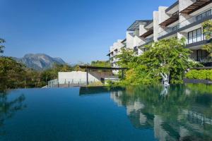 a large pool of water in front of a building at Botanica Khao Yai by Scenical in Mu Si