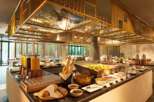 a buffet line in a restaurant with food on it at Botanica Khao Yai by Scenical in Mu Si