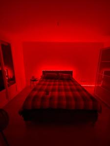 a red bedroom with a bed with a red wall at Cosy Colour Place in Villiers-sur-Marne