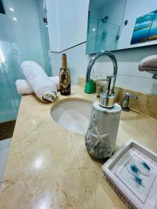 a bathroom counter with a sink with aaucet at morros luxury beach in Cartagena de Indias