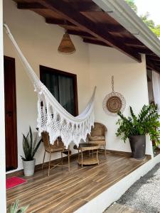 a hammock on the porch of a house at Pousada e Restaurante Sumaúma in Santarém