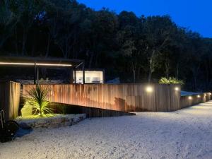 a house with a wooden fence at night at Villa STEVAN in Bonifacio