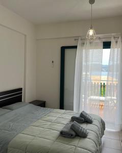 a bedroom with a bed with two towels on it at Reis Villa in Nikiana +30 photos