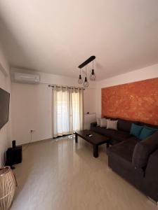 a living room with a couch and a table at Reis Villa in Nikiana